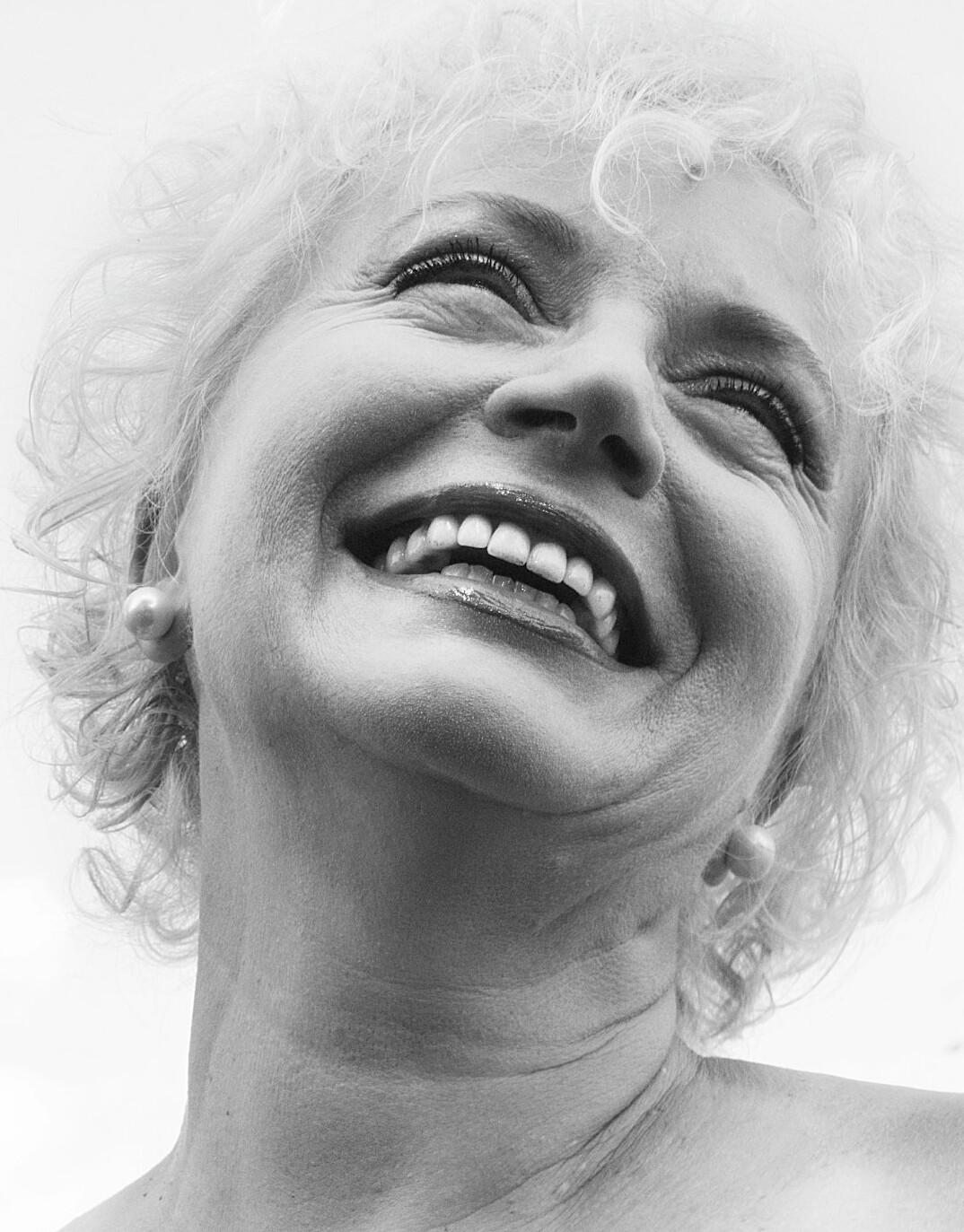Portrait of a smiling senior woman with white curly hair