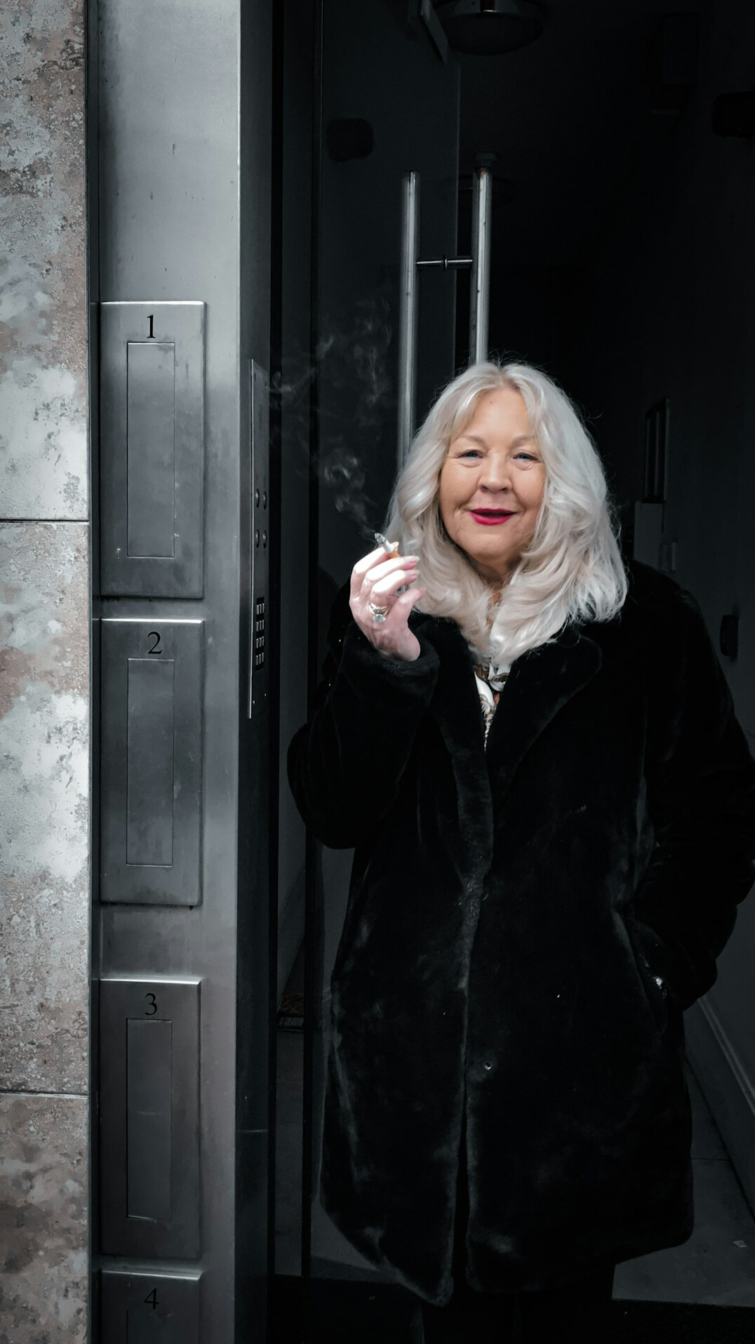 Portrait of a joyful senior woman with a silver bob haircut