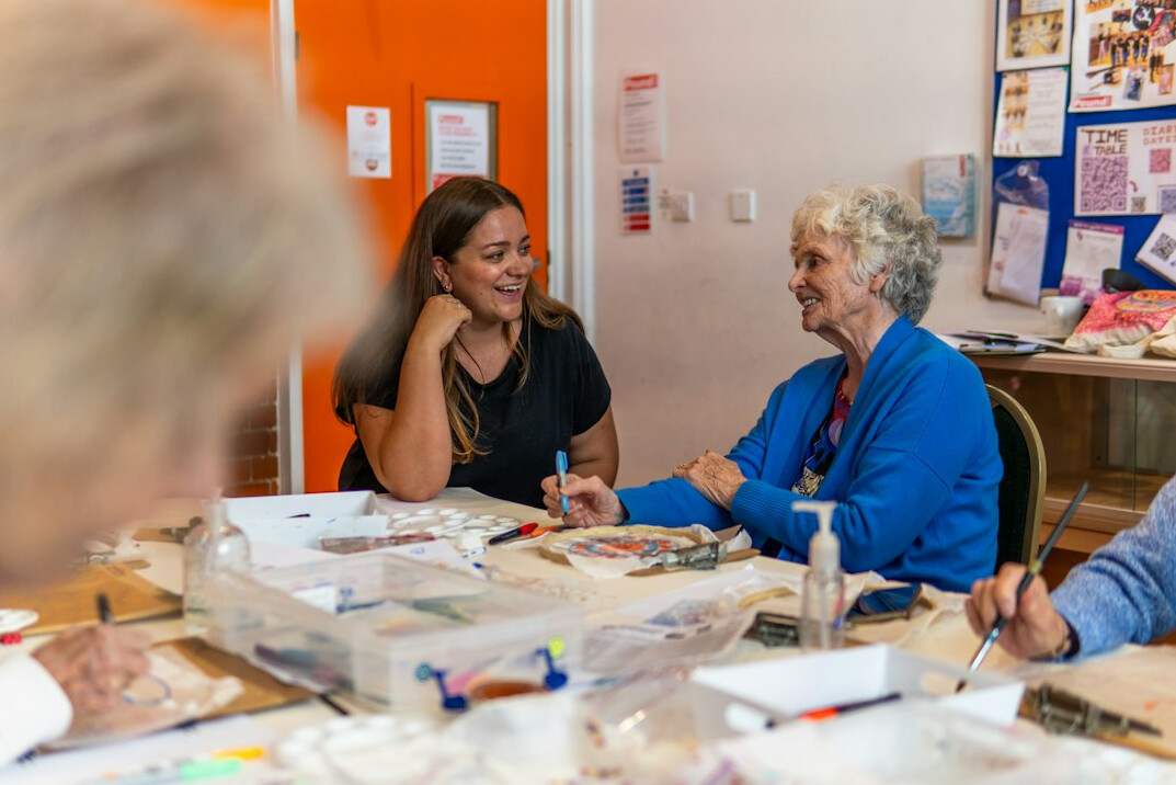 seniors chatting warmly in community hall