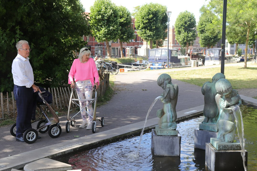 elderly couple walking in park