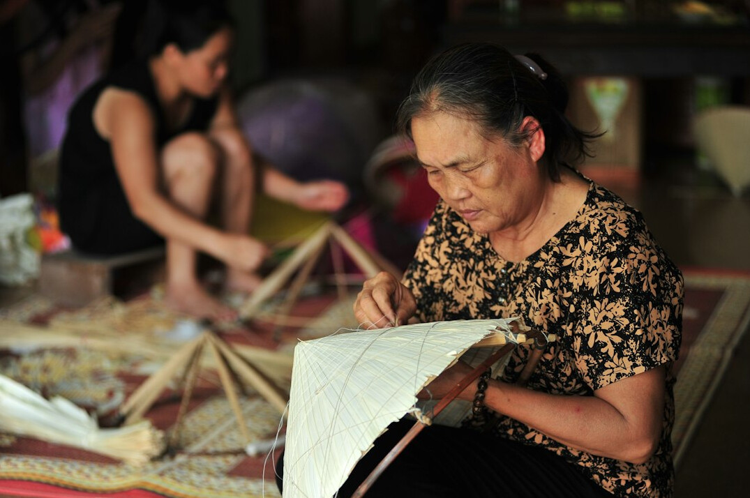 Senior women painting and crafting together at a creative workshop table
